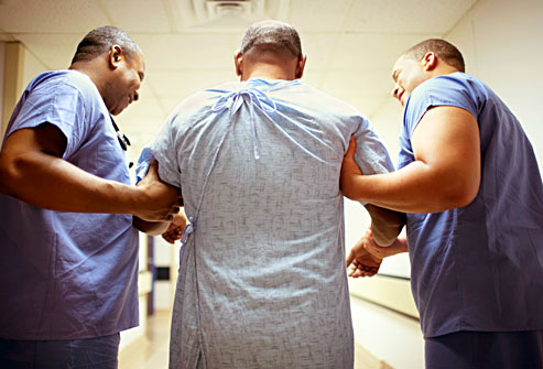 getty_rm_photo_of_patient_being_assisted_by_orderlies