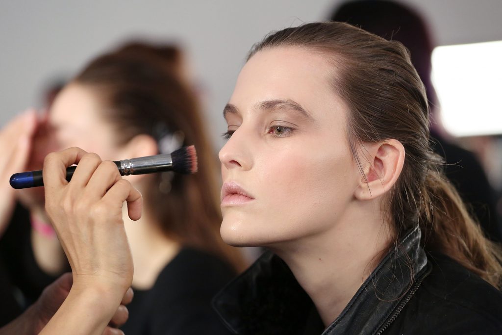 NEW YORK, NY - FEBRUARY 12: A model gets makeup applied backstage at Jonathan Simkhai presentation during MADE Fashion Week Fall 2015 at Milk Studios on February 12, 2015 in New York City. (Photo by Mireya Acierto/Getty Images)